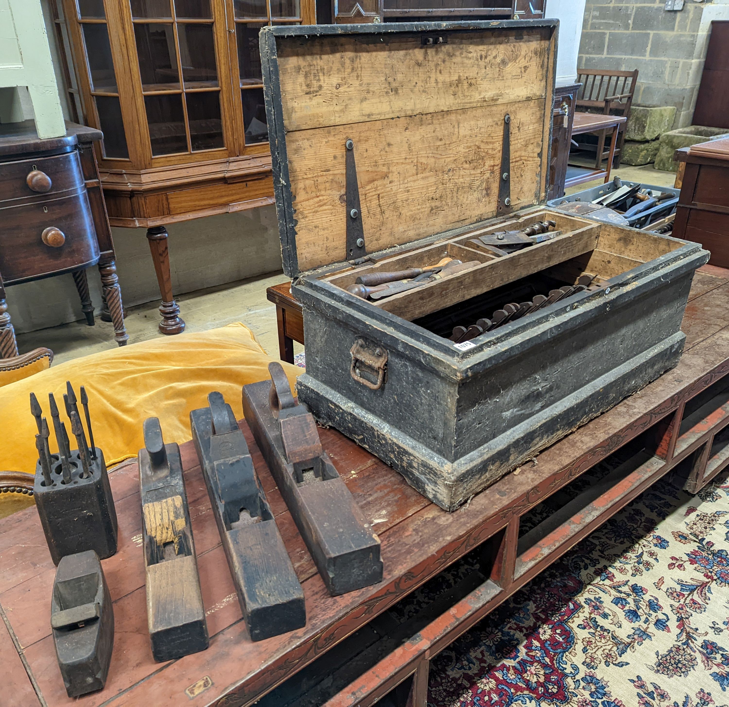 A Victorian pine carpenters chest and tools to include beech moulding planes, smoothing planes, chisels, bits, etc.